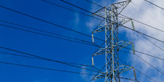 Transmission tower with numerous power lines, set against a clear blue sky. Transmission tower with numerous power lines, set against a clear blue sky.