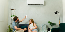 couple in apartment adjusting heat pump couple in apartment adjusting heat pump
