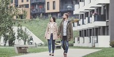Two people walking in a residential area Two people walking in a residential area