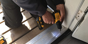 Construction worker uses cordless drill doing renovation work at home. Construction worker uses cordless drill doing renovation work at home.