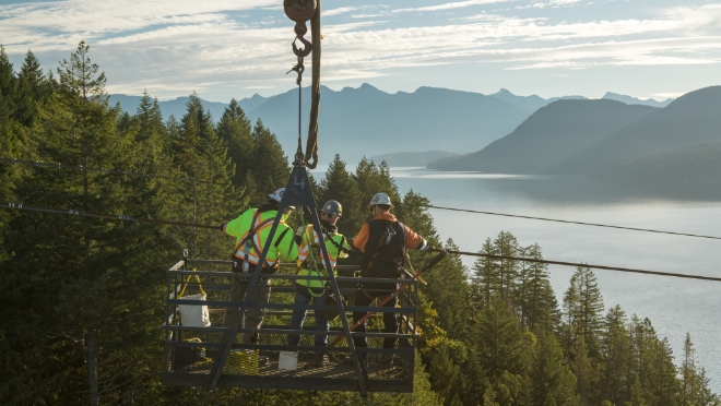 Detonation specialists work with a BC Hydro power line technician to secure the detonation device on the conductor.  Detonation specialists work with a BC Hydro power line technician to secure the detonation device on the conductor.