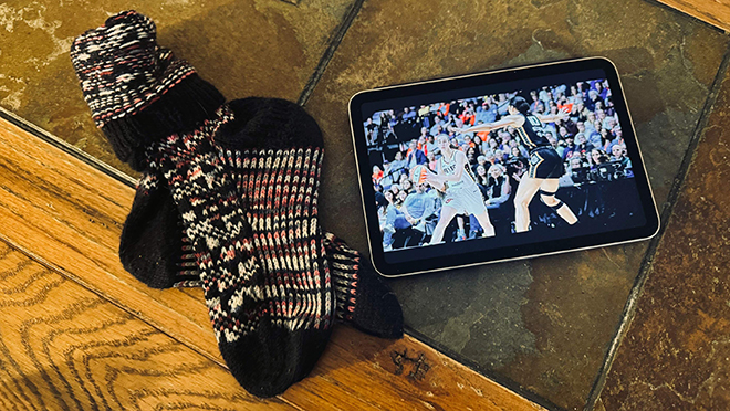 iPad with Caitlin Clark on screen and knitted socks