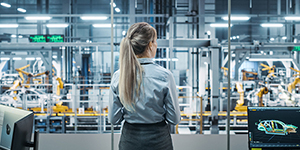 Car Factory Office: Woman Overlooking Factory Production Conveyor