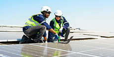 Two contractors installing solar panels