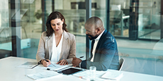 A business people and a clients reviewing some paperwork