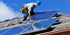 Man installing rooftop solar panels