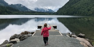 Young child at dock on a lake.