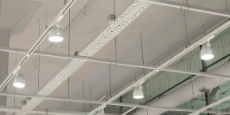 Ceiling with bright directional LED lights on rails lights in a modern building or warehouse.