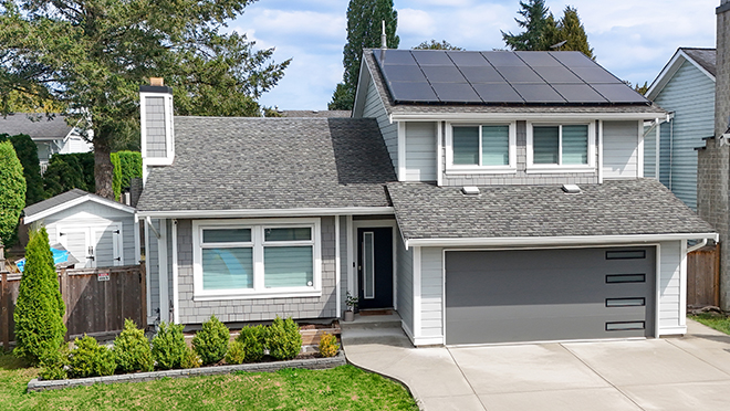 Exterior of residential house with solar panel system installation on roof