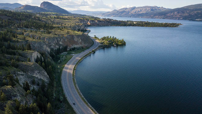 Aerial panoramic view of Okanagan Lake during a sunny summer day.