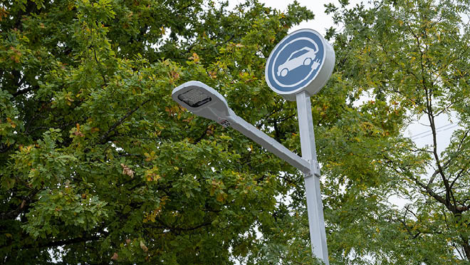 EV charging station sign mounted on a tall post