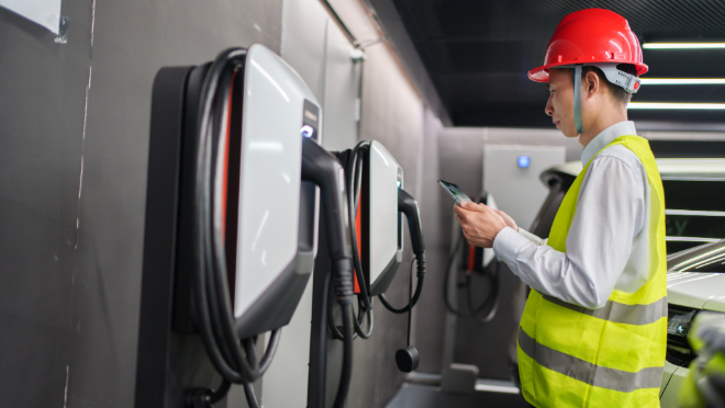 Engineer inspecting an electric vehicle charging stations.