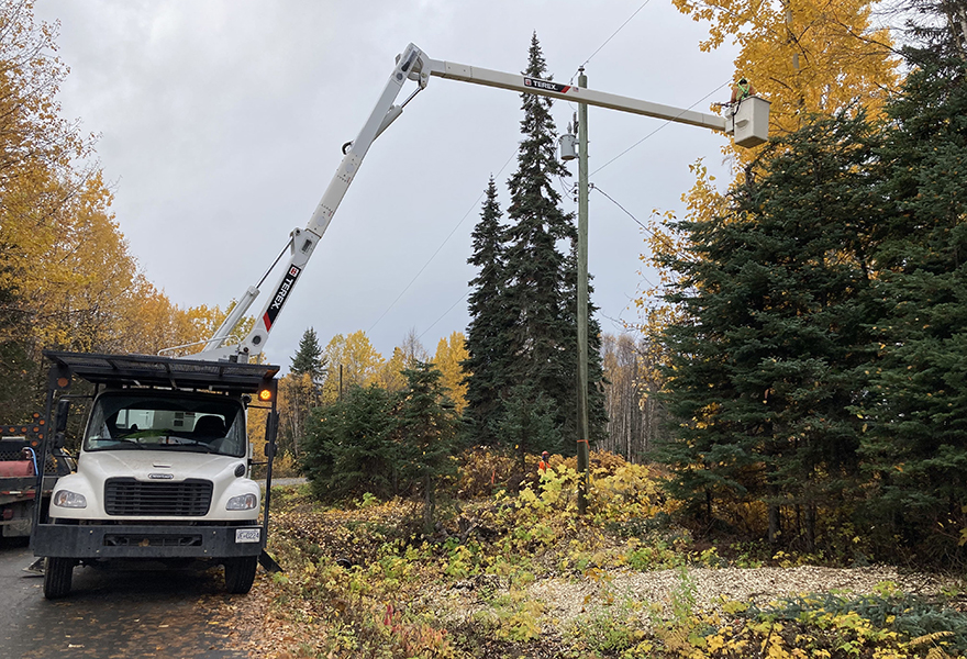 Vegetation crew using a truck to maintain trees close to power lines. 